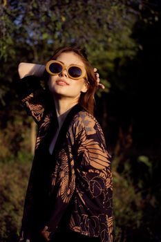 woman wearing sunglasses outdoors posing fashion. High quality photo