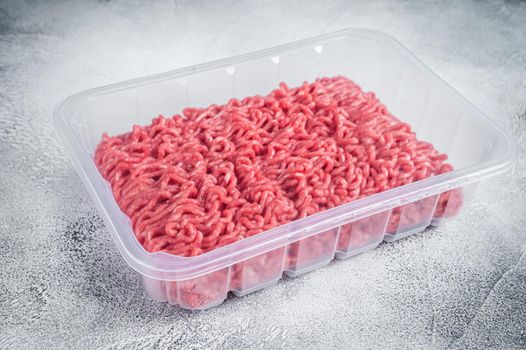 Raw ground beef and pork meat in vacuum packaging from super market. White background. Top view.