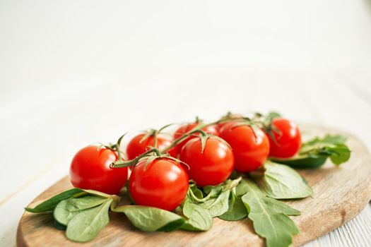 cherry tomatoes lettuce leaves wooden board fresh food. High quality photo