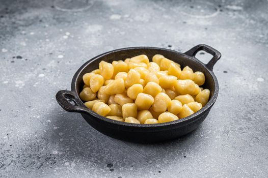 Cooked Gnocchi with Butter and Pepper. Gray background. Top view.