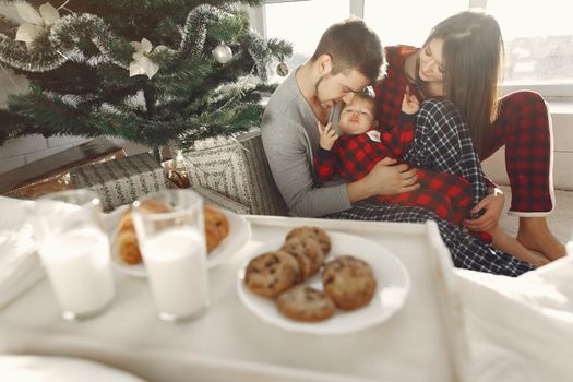 People at home. Family in a pajamas. Milk and croissants on a tray.