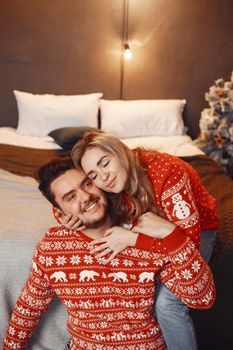 People in a Christman decorations. Man and woman in a red sweater. Family at home.