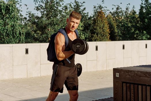 athletic man with dumbbells with pumped up body workout. High quality photo