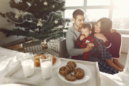 People at home. Family in a pajamas. Milk and croissants on a tray.