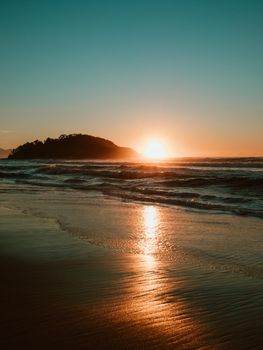 Sunrise on the beach and ocean waves on a tropical sea. High quality photo