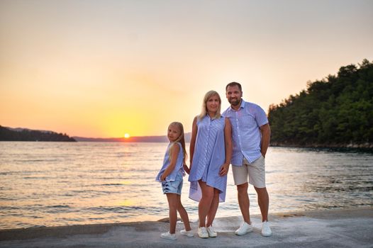 beautiful family On the pier by the sea during sunset. Turkey.