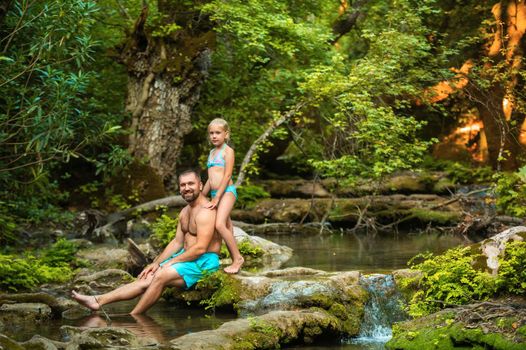 A father and daughter family on a mountain river in the jungle.Turkey.
