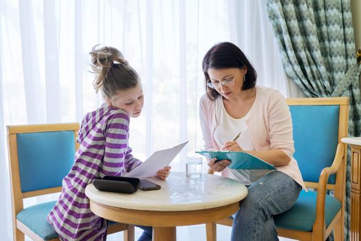 Pre-adolescent girl at consultation with therapist, social worker, counselor in office. Psychology, education, therapy, mental health, children concept