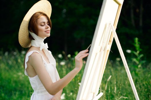 Woman in white dress artist hobby nature landscape. High quality photo
