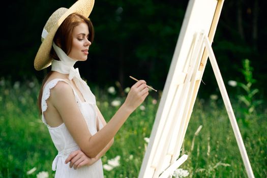 Woman in white dress artist hobby nature landscape. High quality photo