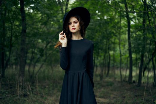 woman dressed as a witch in the forest Halloween fantasy ritual. High quality photo