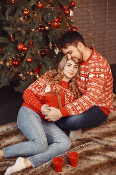 People in a Christman decorations. Man and woman in a red sweater. Family at home.