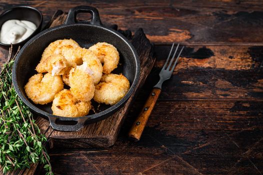 Fried Breaded Shrimps Prawns in a pan. Dark wooden background. Top view. Copy space.