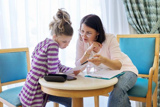 Pre-adolescent girl at consultation with therapist, social worker, counselor in office. Psychology, education, therapy, mental health, children concept