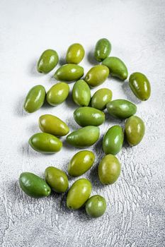 Fresh Green big olives on a table. White background. Top view.