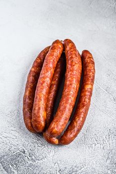 Hot Smoked sausages on a rustic table. White background. Top view.