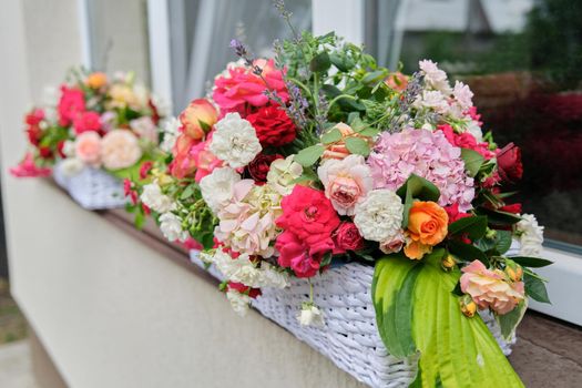 Flower arrangement in a basket. Flower decoration of events, floristry, natural beauty, holidays concept