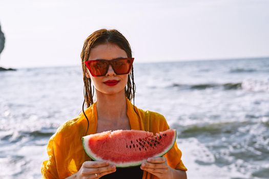 woman in swimsuit with watermelon outdoors sun fresh air. High quality photo