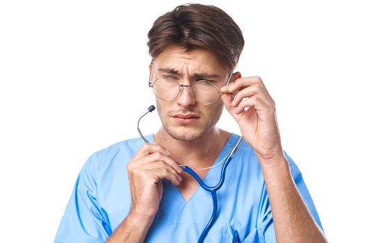 male doctor wearing glasses stethoscope posing light background. High quality photo