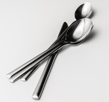 Spoon, fork and knife on a white background. Close up.