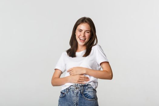 Happy beautiful woman laughing at something funny.