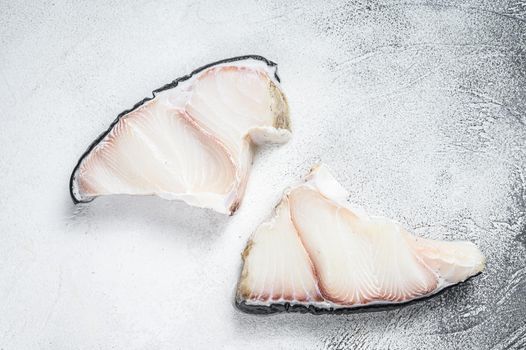 Raw Shark fish steaks on a kitchen table. White background. Top view.