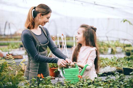 mother and daughter taking care of plants