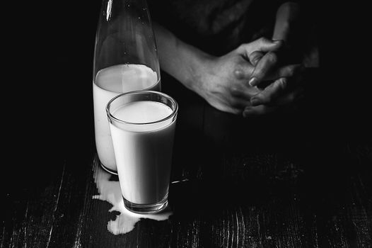 woman farmer with a glass of milk. concept problems in the agricultural sector.