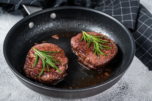 Grilled Fillet Mignon tenderloin meat beef steaks in pan. White background. Top view.