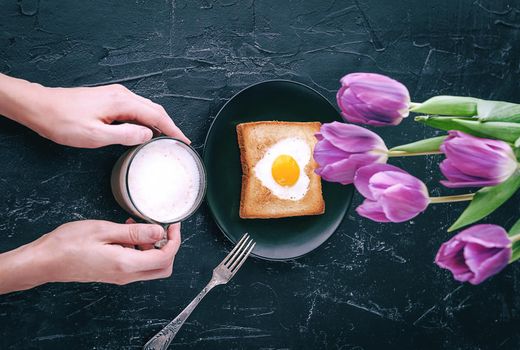 Still breakfast for a loved one with tulips on a dark background