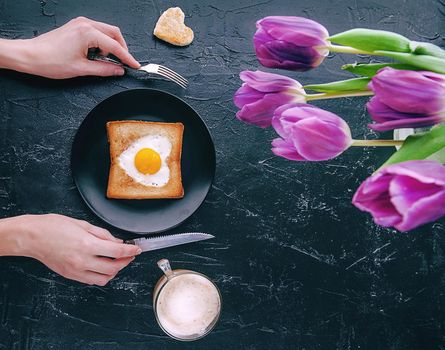 Still breakfast for a loved one with tulips on a dark background