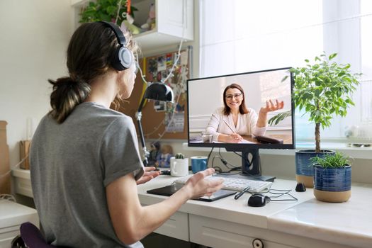 Online consultation of male teenager by social worker psychologist behavior teacher. Virtual meeting, using video call on home computer. Technologies, communication, help, mental health of adolescents