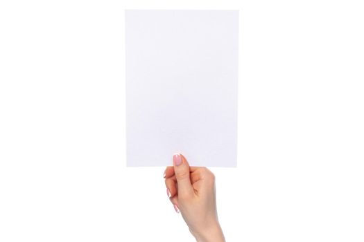 Female hand holding blank white sheet of paper isolated on white background