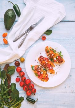 Bruschetta with cheese, basil, arugula and cherry tomatoes