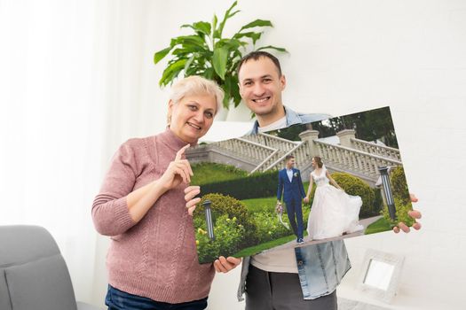 a man and a woman holding a photo canvas