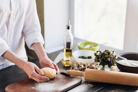 Step by step the chef prepares ravioli with ricotta cheese, yolks quail eggs and spinach with spices. The chef works with the dough