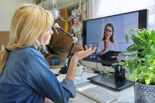 Online consultation of female teenager by social worker psychologist teacher. Virtual meeting, using video call on home computer. Technologies, communication, help, mental health of adolescents