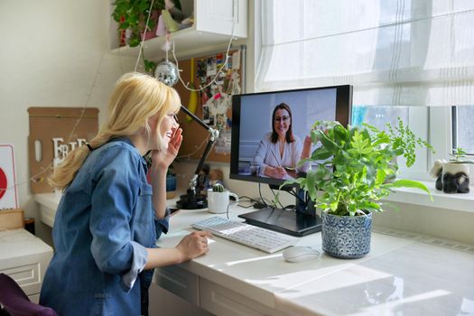 Teen girl talking online with psychologist, social worker. Teenager sitting at home using video call on computer for virtual meeting with counselor. Technology, adolescence, mental health