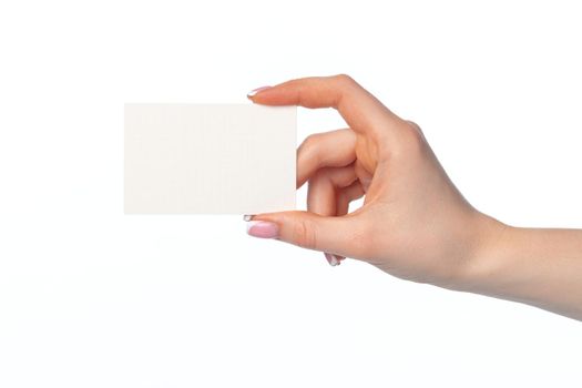 Female hand with blank white business card isolated on white background