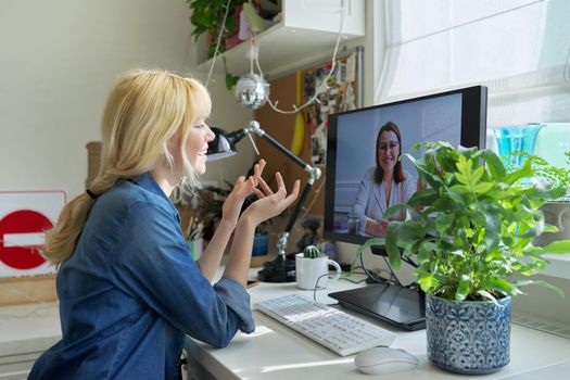 Teen girl talking online with psychologist, social worker. Teenager sitting at home using video call on computer for virtual meeting with counselor. Technology, adolescence, mental health