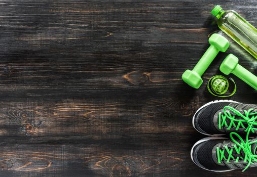 Sneakers dumbbells and a bottle of water. Flat view. All in one color.