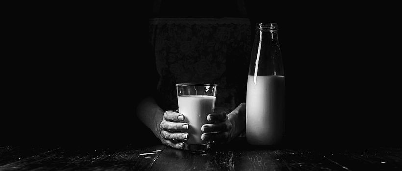 woman farmer with a glass of milk. concept problems in the agricultural sector.