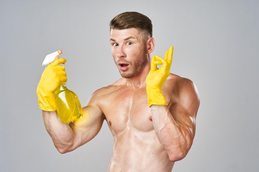 muscular man wearing rubber gloves posing homework. High quality photo