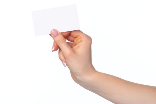 Beautiful female hand holding white business card isolated on white background