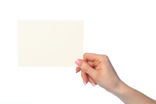 Woman's hand holding blank white sheet of paper isolated on white background