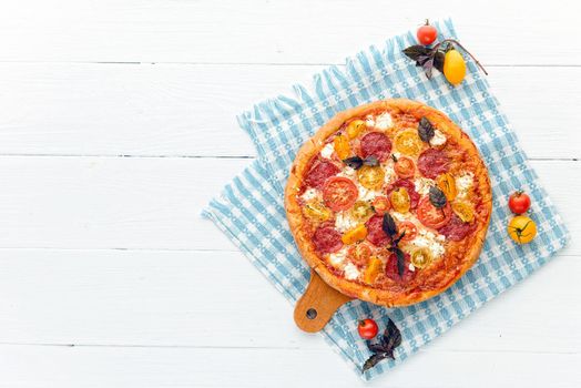 pepperoni italian pizza with salami and cheese on rustic wooden white background