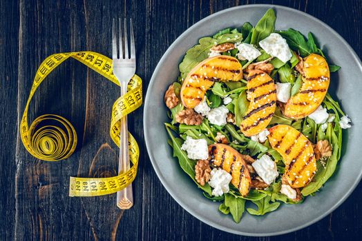 Salad of peaches grilled, ricotta and arugula. Healthy food