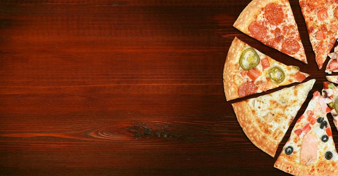 mix of eight different pizzas on a wooden background. menu concept of choice and diversity