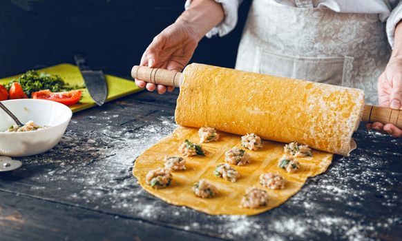 Woman chef cooks step by step the traditional ravioli