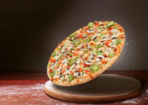 classic pizza on a dark wooden table background and a scattering of flour. pizza restaurant menu concept